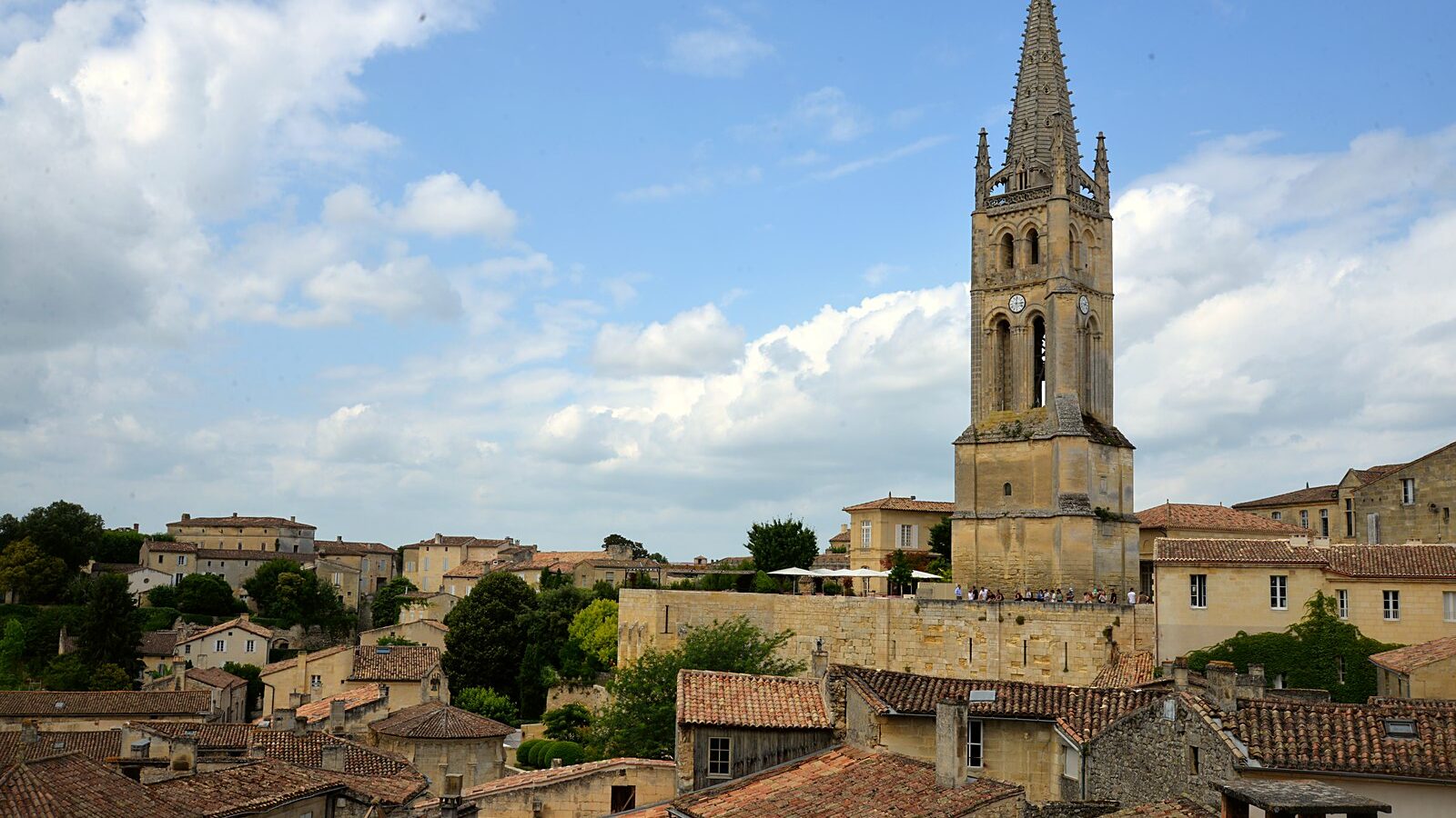 Le clocher de l'église monolithe de Saint-Émilion dominant les toits de tuiles du bourg